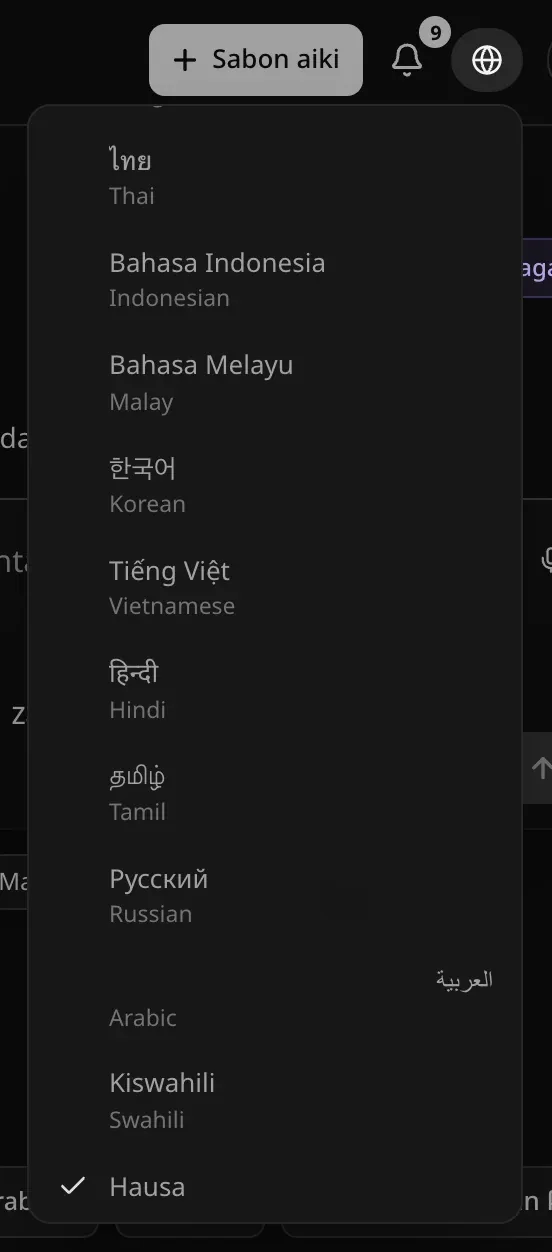 Menu na harshe a buɗe a ƙarƙashin alamar duniya, an gungura shi zuwa Hausa, wanda yake da alamar zaɓi; sauran harsuna a rubutunsu na asali — ไทย, Bahasa Indonesia, 한국어, हिन्दी, Русский, العربية, Kiswahili da sauransu — kowanne da sunansa a ƙarƙashinsa