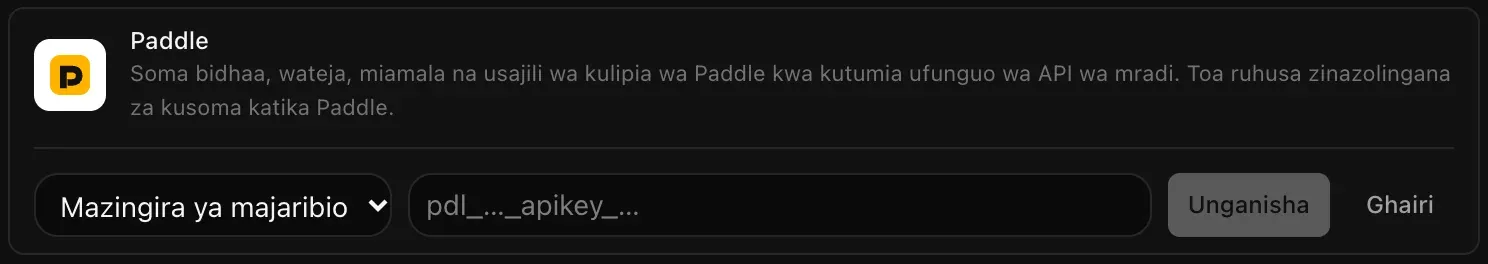 Safu ya Paddle ikiwa wazi kwa ajili ya kuunganisha: menyu ya Mazingira ya majaribio au Mazingira halisi, sehemu tupu ya Ufunguo wa API wa Paddle, na vitufe vya Unganisha na Ghairi